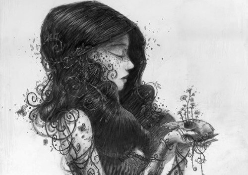 Kvinde holder plante i hænderne