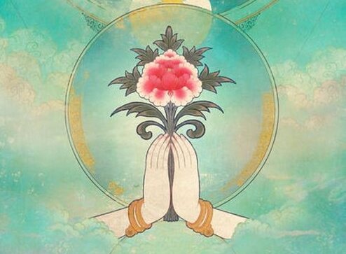 Hænder foldet om blomst