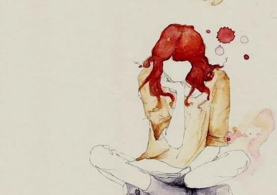 Kvinde med rødt hår sidder på gulv