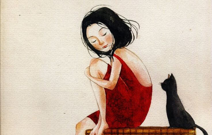 Kvinde i rød kjole sidder med kat