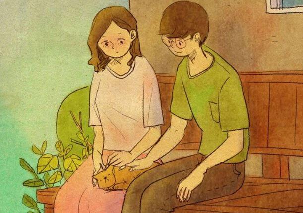 Par sidder og kæler med kat