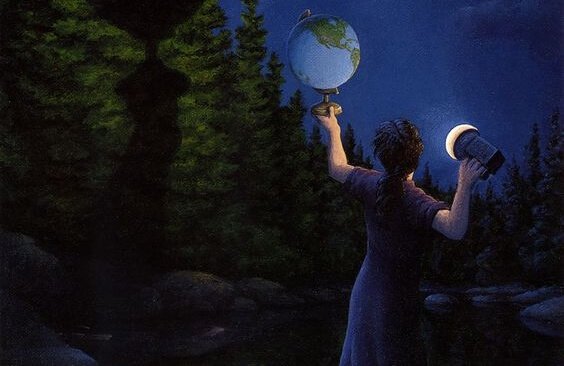 Person lyser på globus