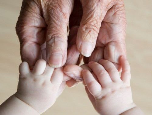 Baby og ældre persons hænder viser et tæt bånd mellem børnebørn og bedsteforældre