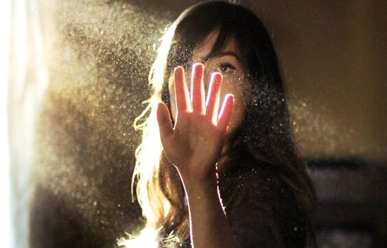 Kvinde med hånden op mod lyset har en sjette sans