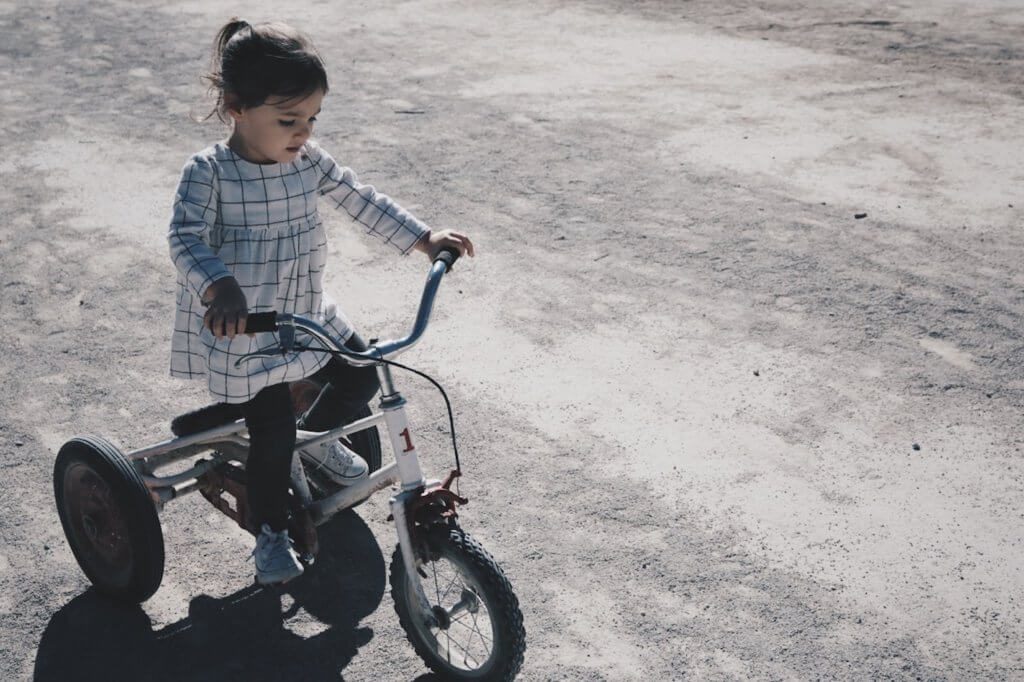 Pige leger på cykel for at undgå overvægt i barndommen