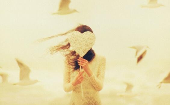 kvinde med hjerte foran ansigt