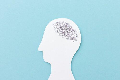 Papirskabelon af hoved med krusseduller viser, at hjernen er fuld af mysterier