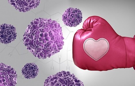 En lyserød boksehandske, der banker kræftceller