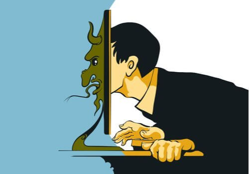 Mand med hoved i computerskærm er eksempel på trolls på sociale medier