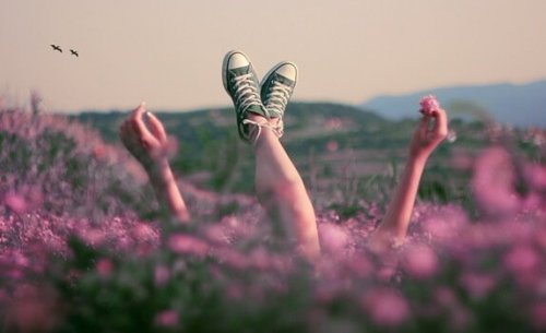 Person ligger i blomstermark