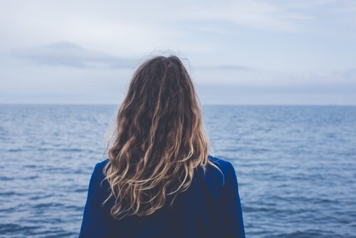En kvinde ser ud over havet
