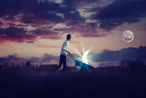 Mand skubber trillebør med månen i