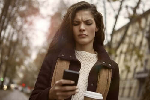 frustreret kvinde, der kigger på sin mobil