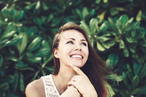 Smilende kvinde forstå, at være positiv er godt for dit selvværd