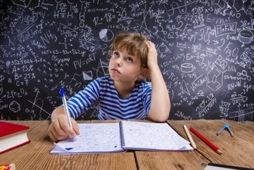 Dreng laver lektier, som er matematik 