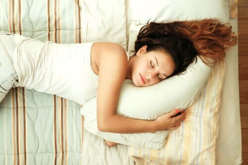 En kvinde, der sover på en seng