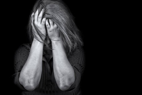 En kvinde med posttraumatisk stress tager sig til hoved