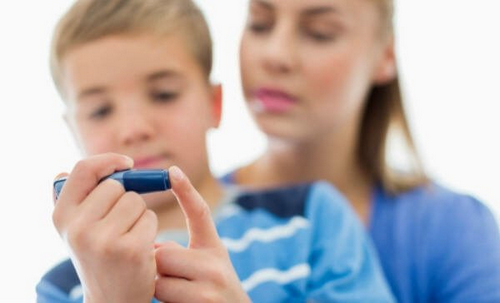 Dreng med diabetes måler sit blodsukker