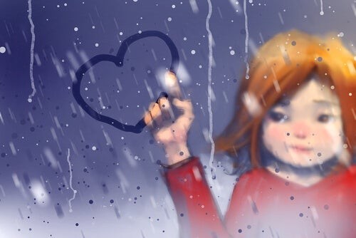 Pige tegner et hjerte på en rude 