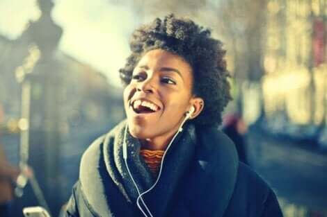 Glad kvinde, der lytter til musik