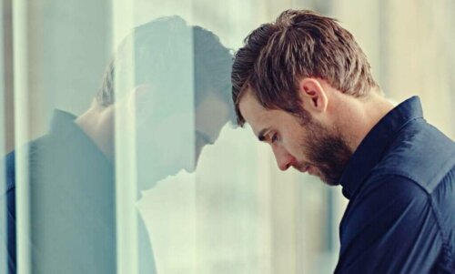 Frustreret mand hviler hoved mod rude