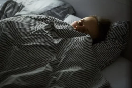 Kvinde sover trygt i sin seng