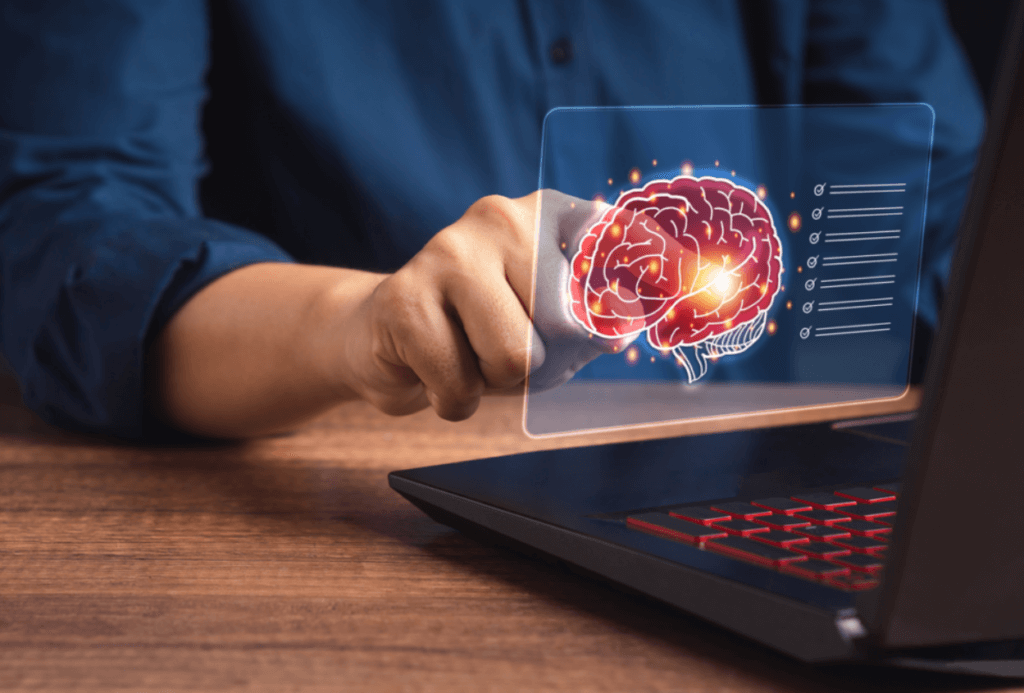 Hjerne svæver foran computer og repræsenterer kunstig intelligens