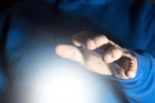 Person med lys under sin hånd oplever ekstrasensorisk perception, som det bliver studeret i Stargate-projektet